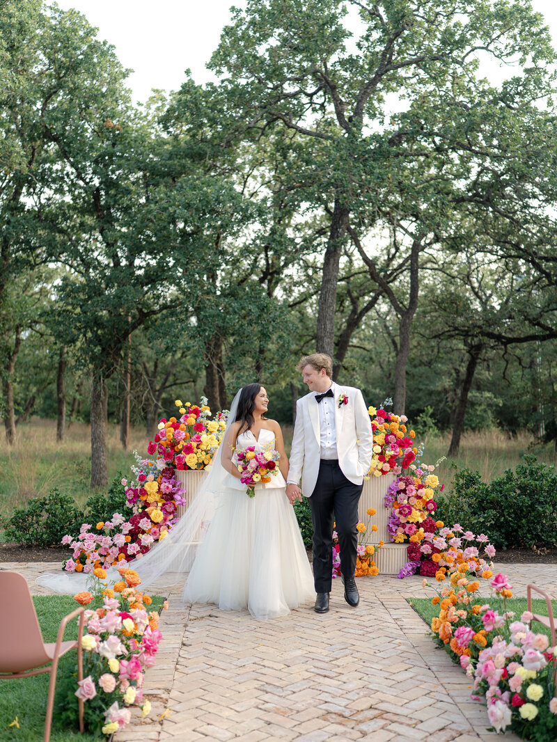bride-and-groom-walking-aisle-outdoor-wedding-ceremony-grand-lady-austin
