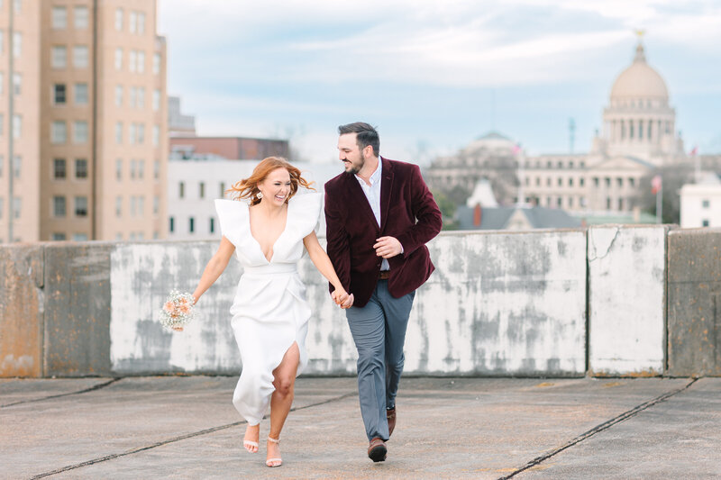 Couple in wedding attire stand on the side of mountain in Colorado elopement at Sapphire Pointe.