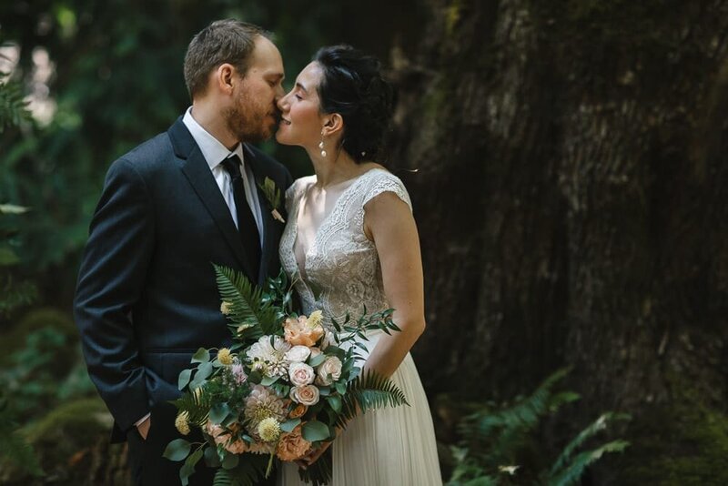 Couple sharing a quiet moment in a forest area of their wedding venue in Seattle.