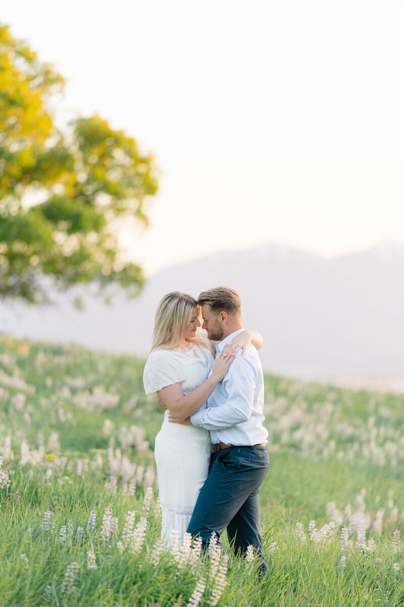 couple hugging in a field of wild flowers