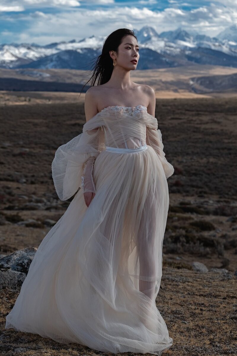 Couture bride shot in dramatic mountain scape.