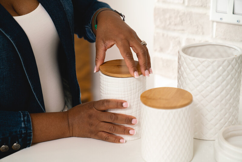 a woman's hand screwing the lid onto a jar
