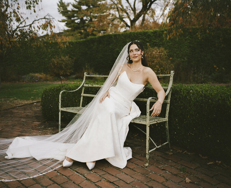 Medium format film photo of a bride on a bench at a Boscobel House & Gardens wedding