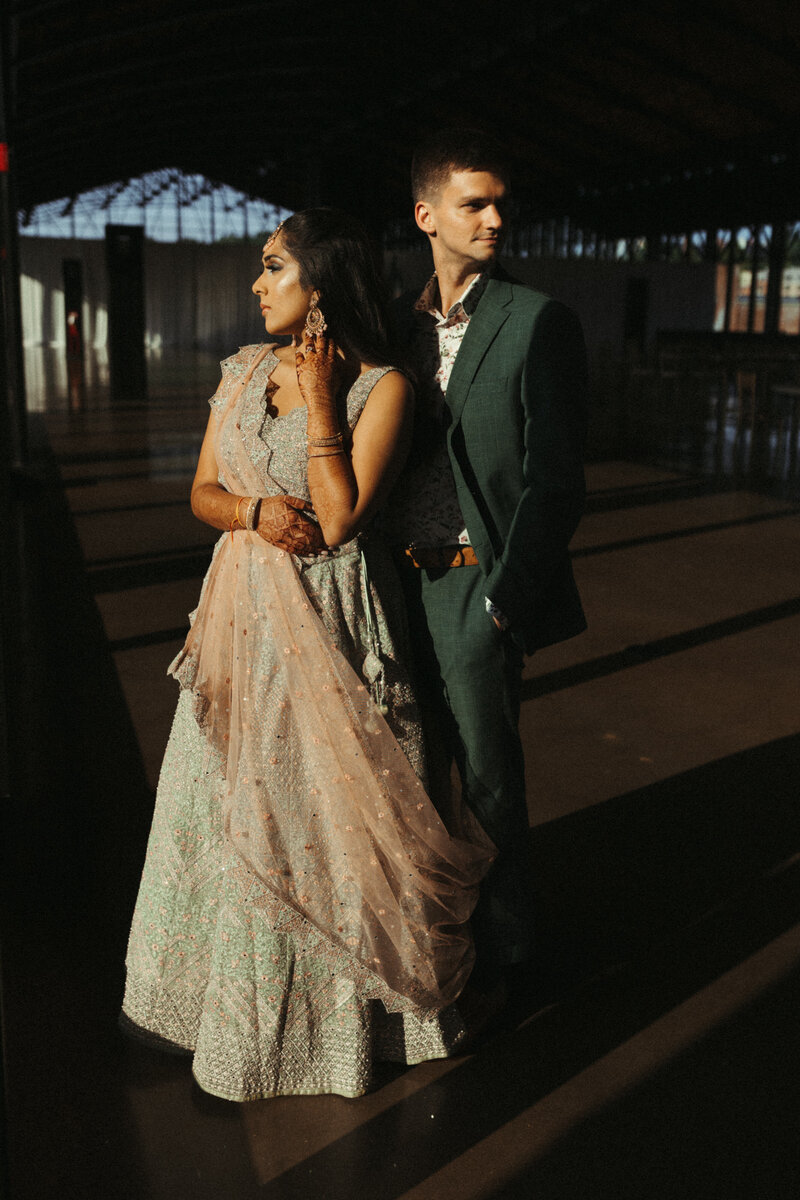 Southeast Asian Wedding Couple standing in the sunlight 