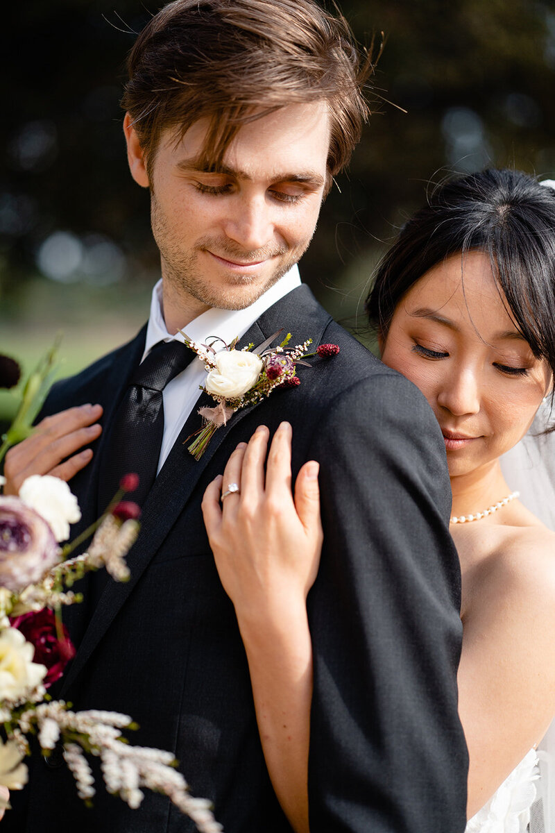 Bride and Groom have a beautiful moment during their portraits in a lush green Los Angeles city garden.