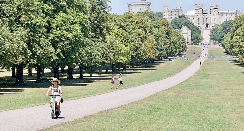 Tourist leaving Windsor Castle on Green Go-Bike M2