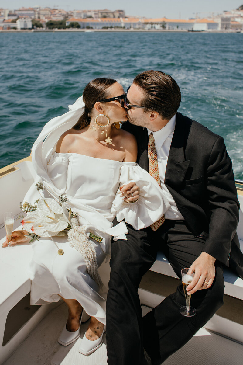 young modern couple kissing during sunset