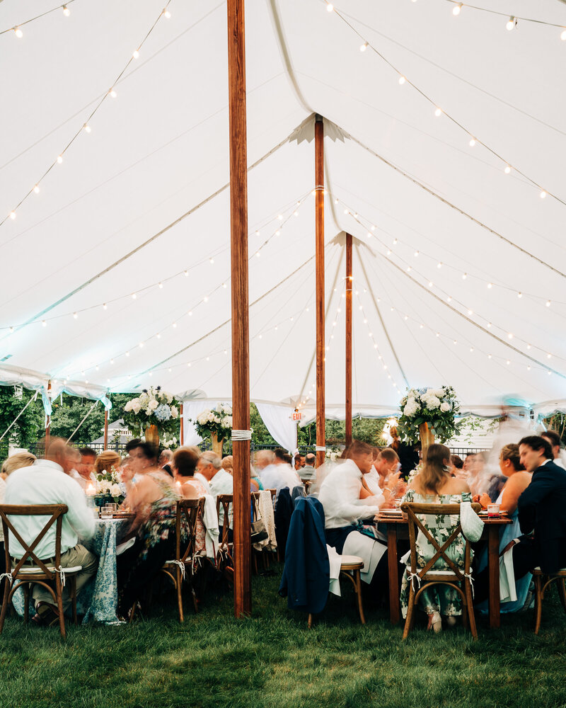 Dinner under a tent during a wedding