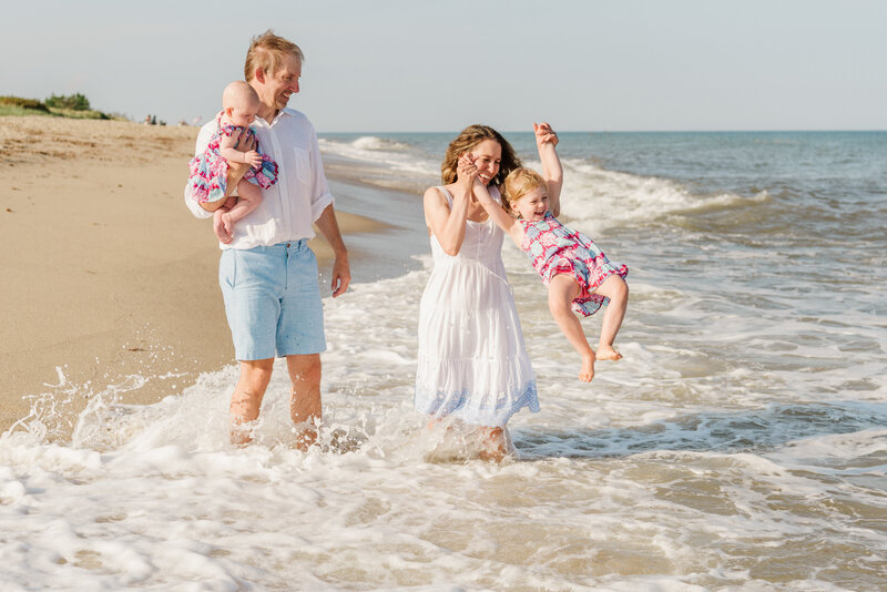 Kids splashing in the ocean Nantucket beach family portraits in Sconset