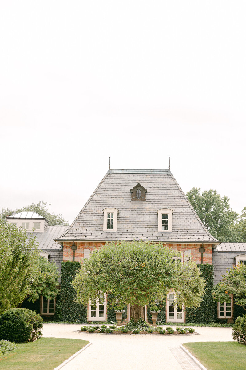 the front of a wedding venue with a well landscaped lawn