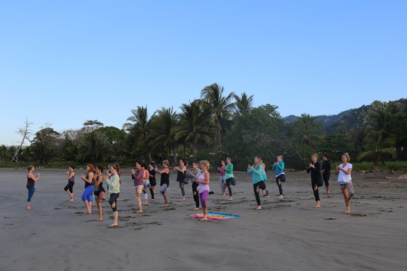 Students and Teacher on the Beach Practicing Yoga in Costa Rica YTT