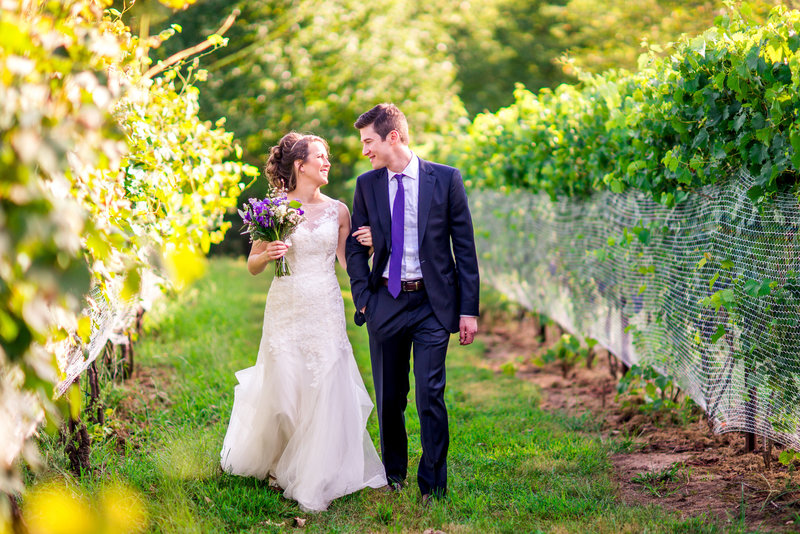 couple walking in rocklands farm vineyard in Maryland