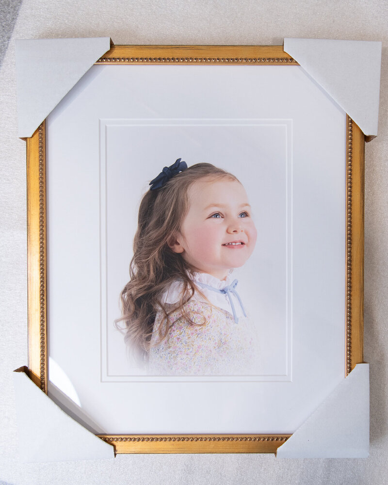 Framed photo of a little girls looking up and smiling