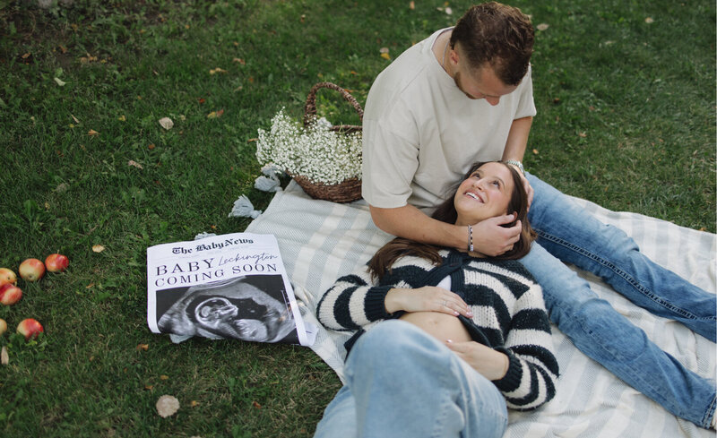 Baby announcement in Idaho Falls ID.  The soon to be mom is lying her head on her husband's lap.