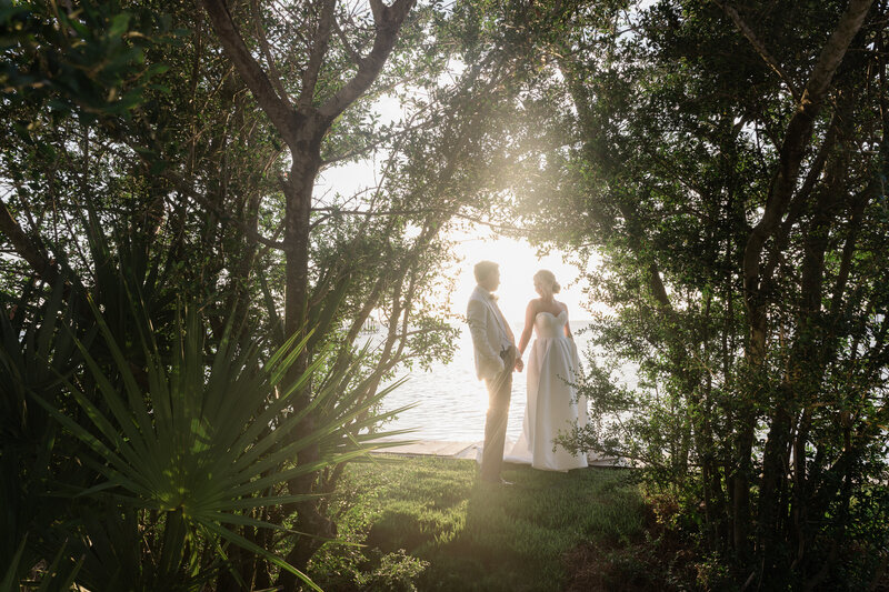 Newlyweds sharing a quiet moment on the beach in Nantucket, with soft coastal light and ocean in the background.