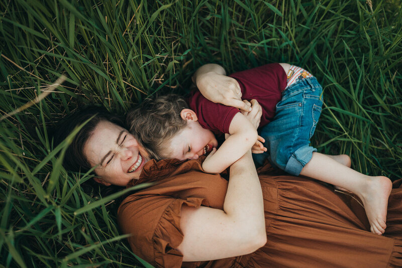 mom-playing-with-her-son-in-grass-at-seattle-park
