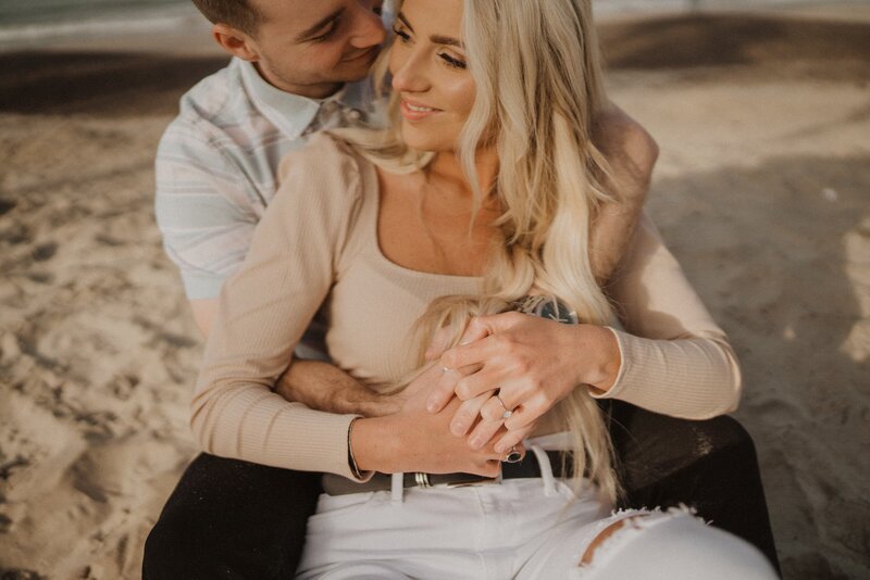 man hugging woman from behind