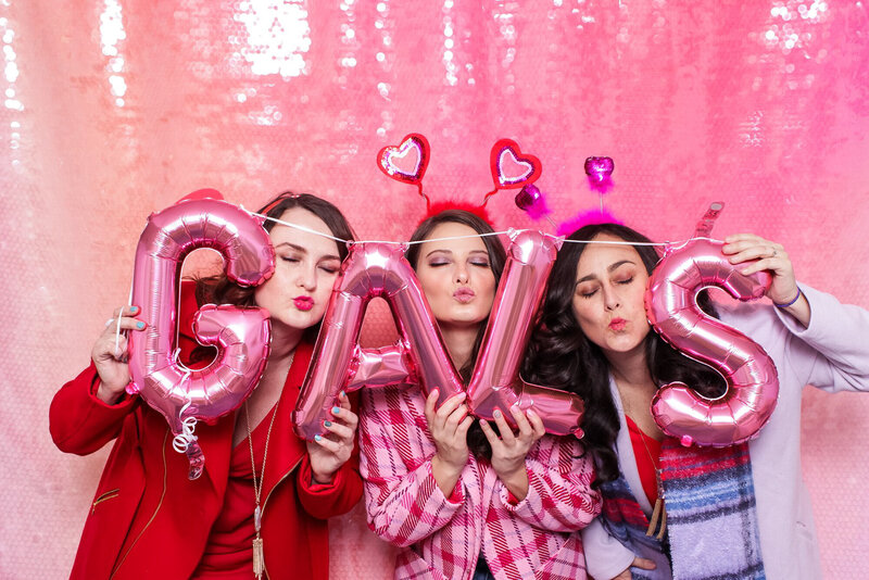 girls having photo booth fun on galentines day