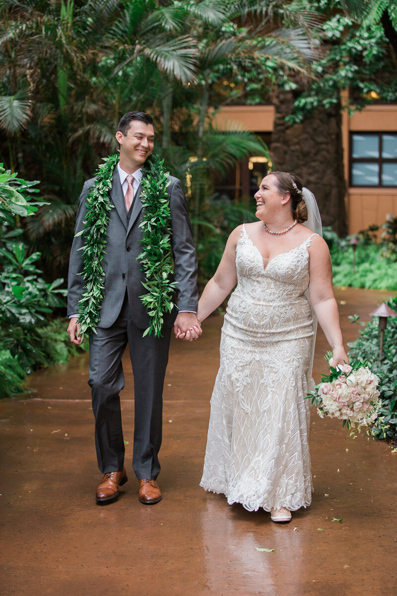 Couple holding hands and smiling after saying I Do at Disney