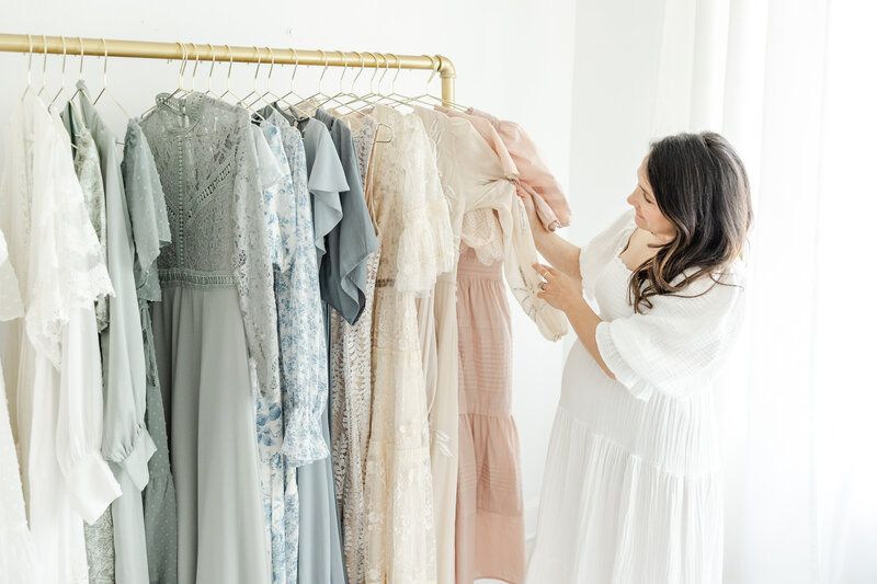 Long flowing dresses hanging on rack before a family portrait session