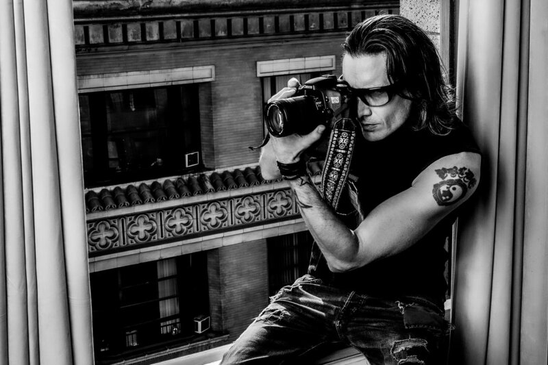 Los Angeles PhotographerMark Maryanovich black and white self portrait sitting on windowsill looking through back of camera