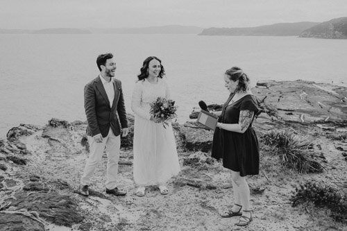 Central Coast Elopement at Bouddi National park. Black and white photograph of a clifftop wedding. Happy and relaxed looking couple.