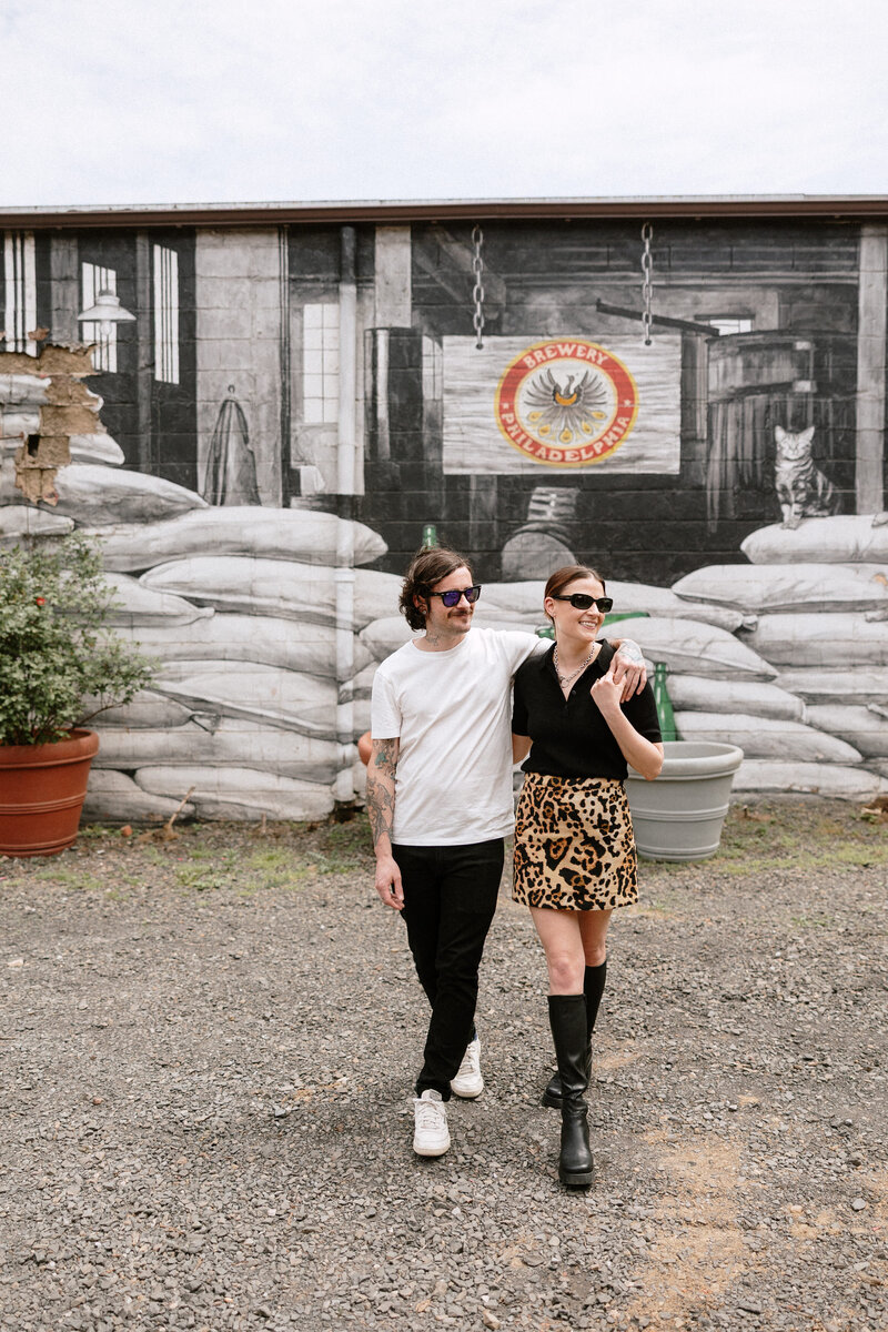 Engaged couple walking hand-in-hand through Philly’s city streets

