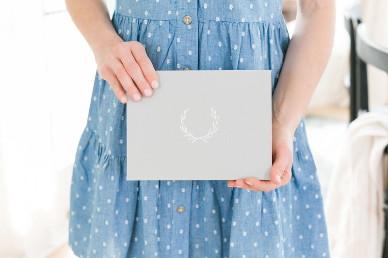 a woman holding wedding stationery
