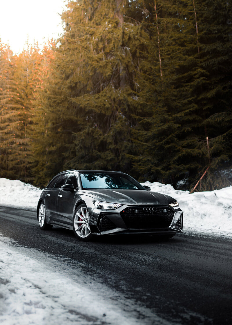 Grey Audi on country road in winter