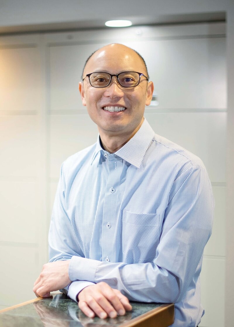 Raymond J. Kao, DMD smiling headshot in Kao Dental office