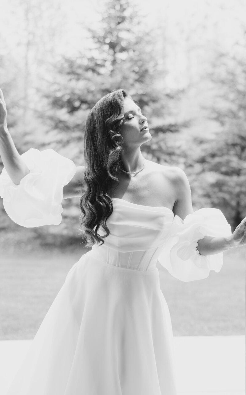 A bride poses and turns her face to the sun
