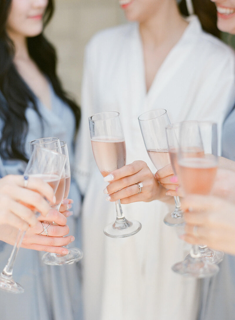 Bride celebrates with her bridesmaids while getting ready for the olana wedding