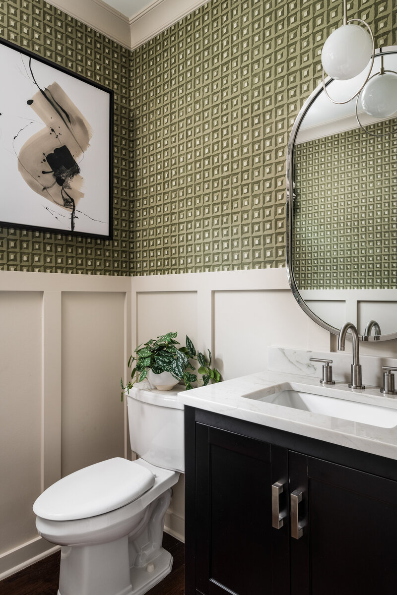 Stylish bathroom in Lake Norman, NC, with patterned wallpaper, a modern vanity, and elegant lighting.