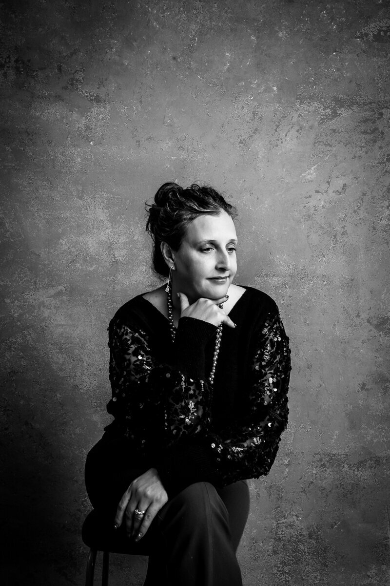 Senior photographer I poses for a portrait in black and white