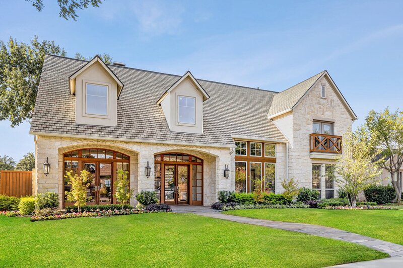 Front exterior of modern stone home with dormers and balcony at 4928 Holly Tree Dr in Dallas, TX, listed by Haven Realty Group and RE/MAX DFW.