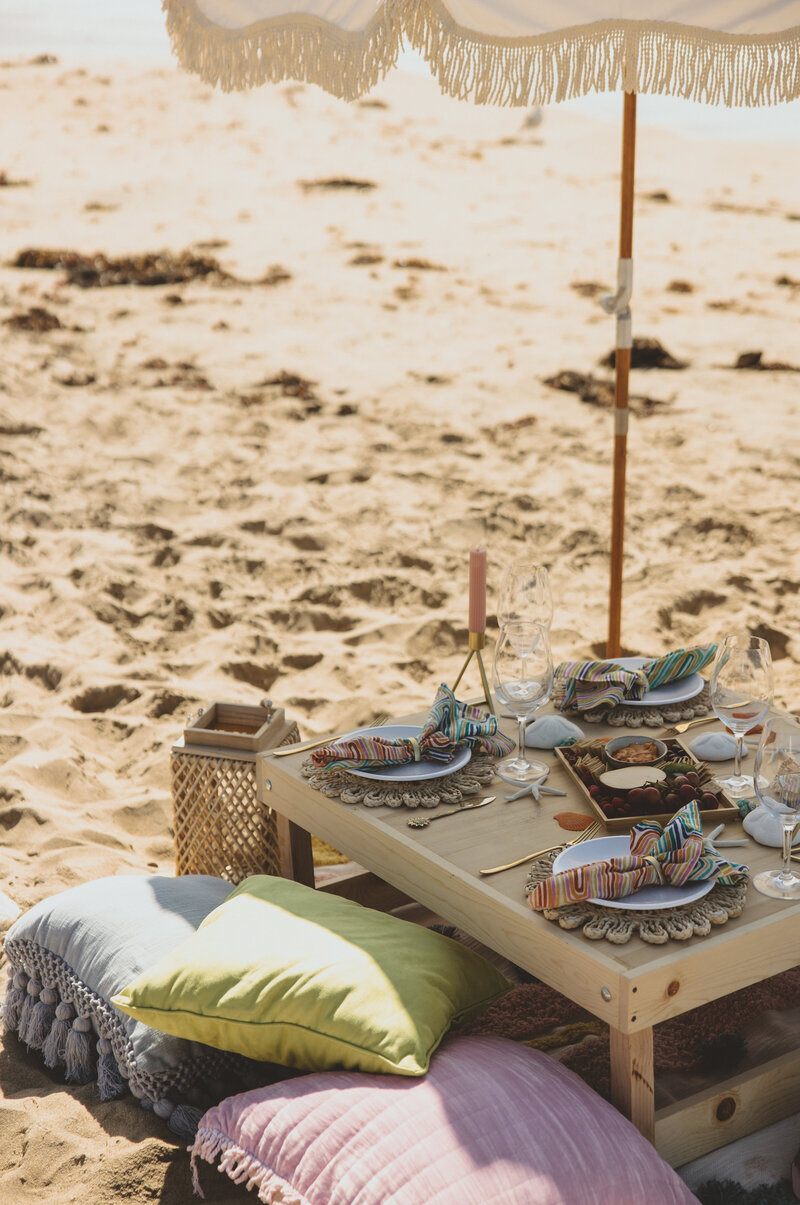 Let's Picnic Co. - Bright and colorful beach picnic and umbrella on beach in Corona Del Mar California