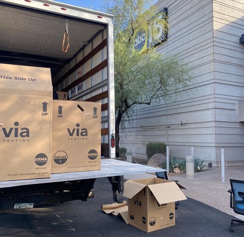 moving truck with boxes outside commercial building