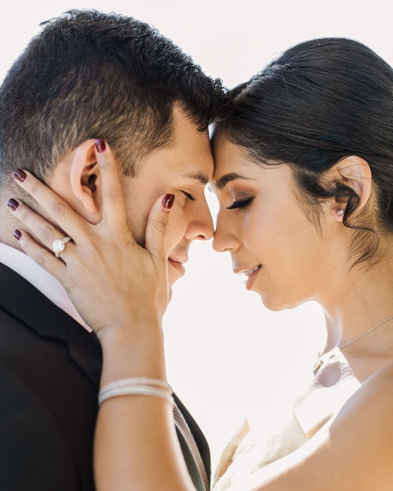 A Beth Sheridan bride kisses her groom after the wedding.