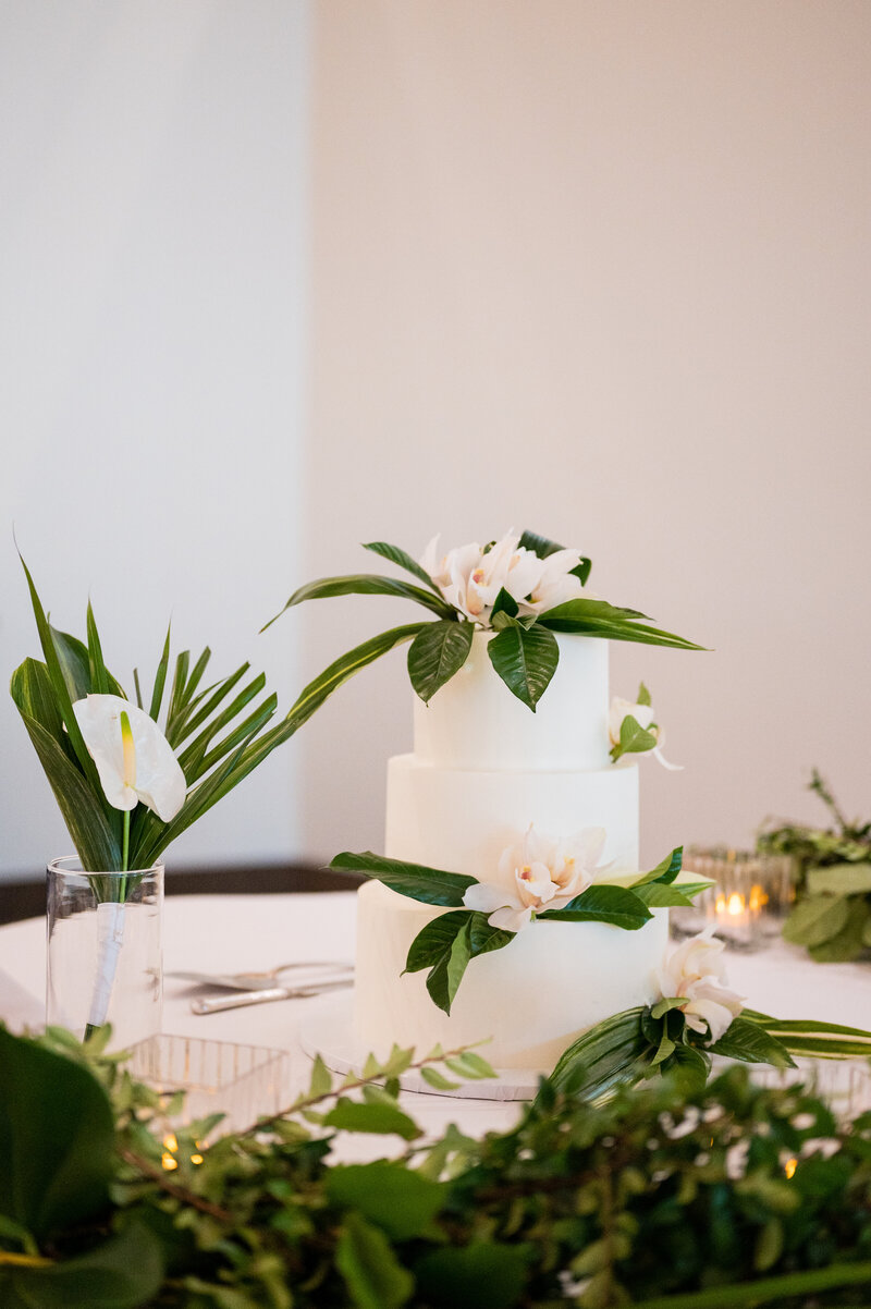 Wedding cake by Las Vegas Custom Cakes styled with white icing and floral accents.
