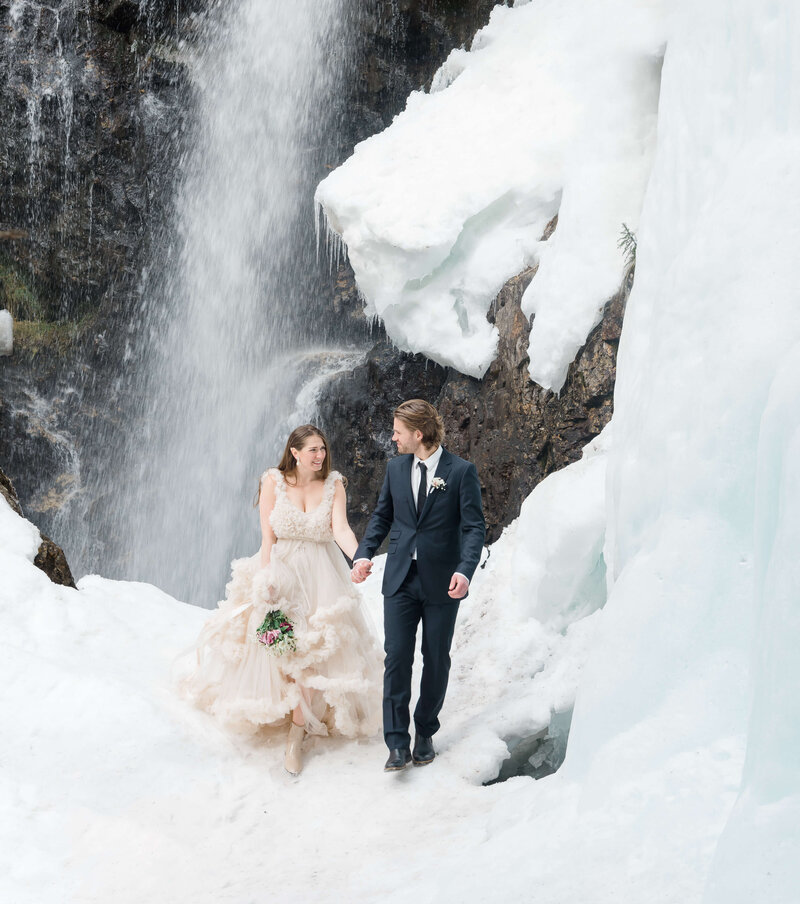 Wedding Photographer Stockholm helloalora snowy winter wedding Vemdalen bridal couple by waterfall