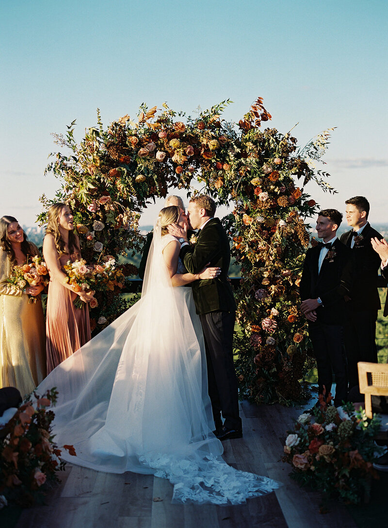 Floral Chandelier hanging floral clouds accent fall wedding reception in Raleigh, NC with roses, hydrangeas, and fall branches in colors of mauve, copper, cream, dusty pink, and green. Design by Rosemary and Finch Floral Design in Nashville, TN.