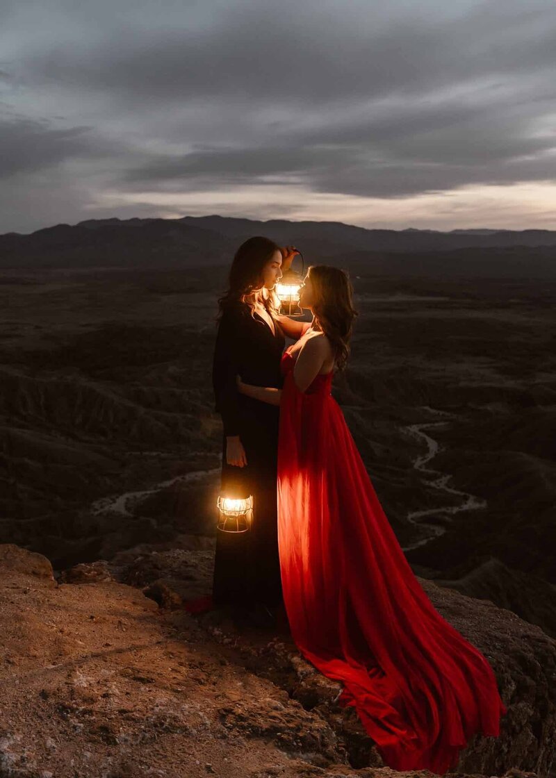 LGBTQ Couple embracing on a cliff in Anza-Borrego