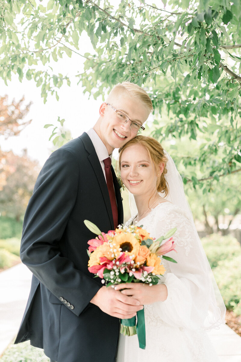 Bride and groom sharing a kiss at the end o the aisle taken by Spokane Wedding Photographer