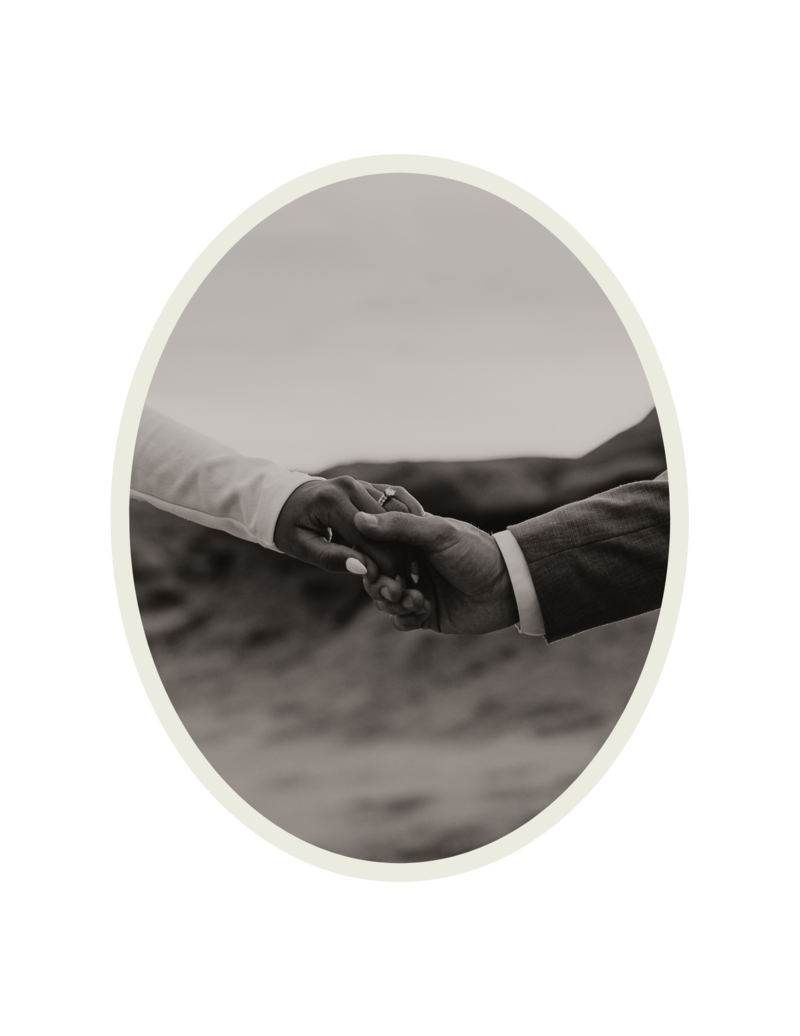 Black and white photo of a couple holding hands showing the wedding ring