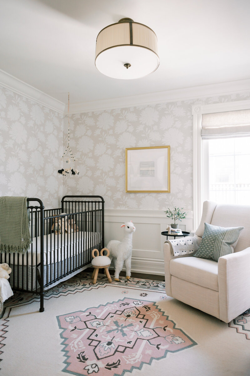 baby room with floral wallpaper vintage rug iron crib linen rocker modern art
