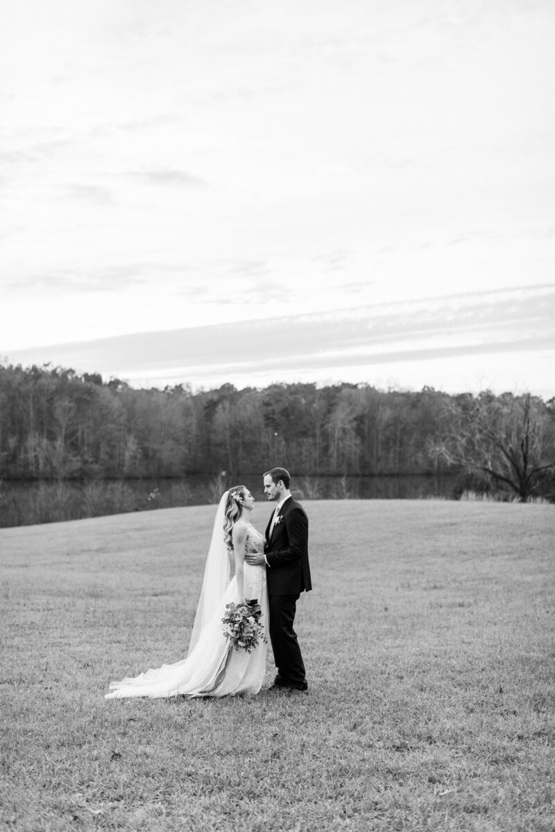 Bride and groom by lake