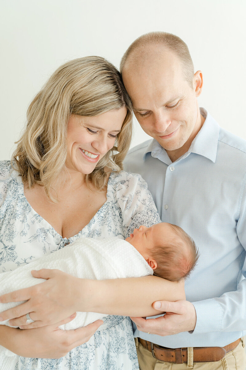 Parents smile at newborn baby boy during photo shoot with Julie Brock Photography in Louisville KY