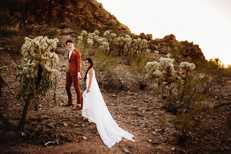 Bride and groom walking through the desert in AZ for their elopement