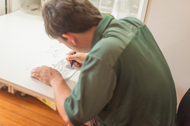 teen boy draws during counseling appointment