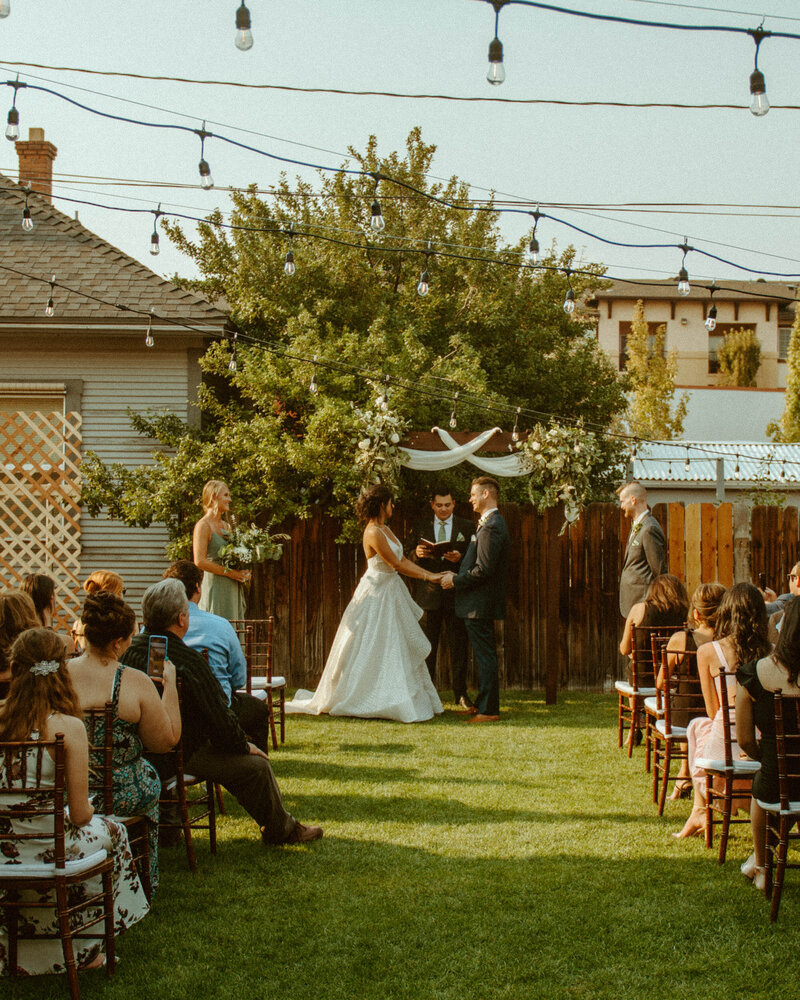 Intimate wedding for biracial couple in Midtown Reno at Calafuria  in midtown downtown Reno, Nevada. Bride is wearing Hayley Paige from Swoon Bridal